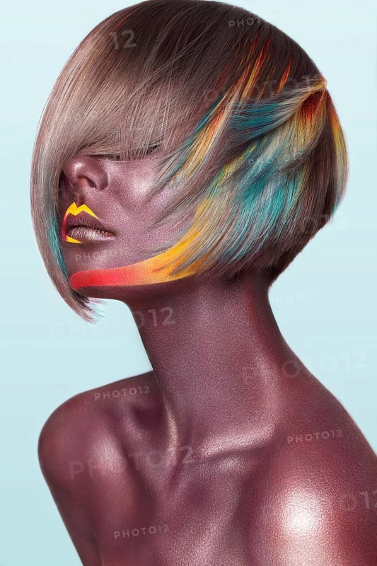 Beautiful girl with multi-colored hair and creative make up and hairstyle. Beauty face. Photo taken in the studio