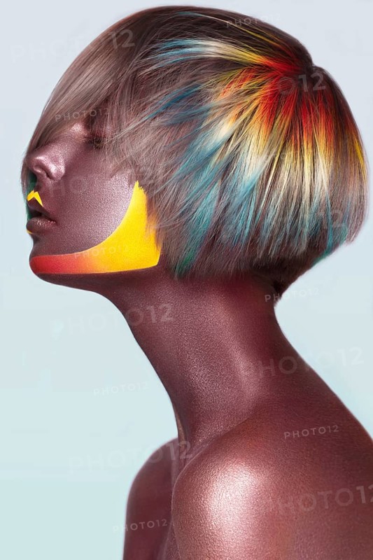 Beautiful girl with multi-colored hair and creative make up and hairstyle. Beauty face. Photo taken in the studio