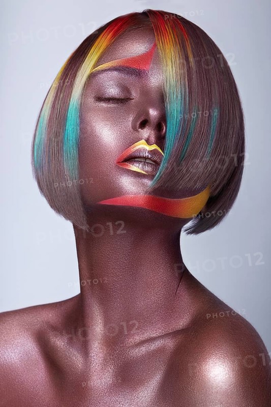 Beautiful girl with multi-colored hair and creative make up and hairstyle. Beauty face. Photo taken in the studio