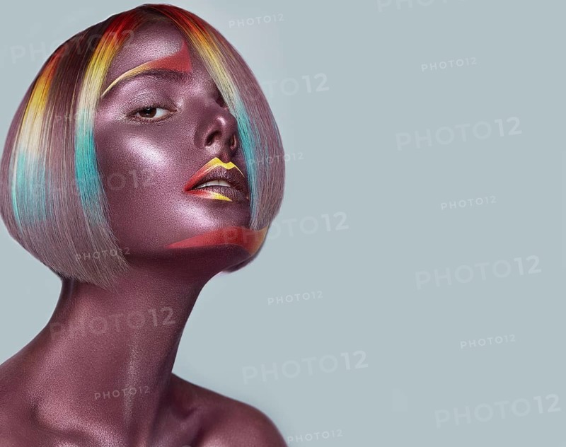 Beautiful girl with multi-colored hair and creative make up and hairstyle. Beauty face. Photo taken in the studio