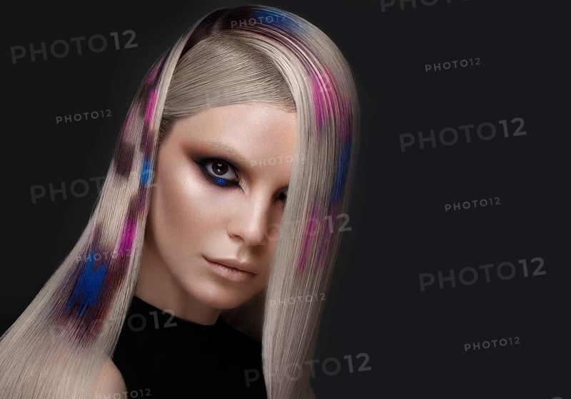 Portrait of beautiful woman with multi-colored hair and creative make up and hairstyle