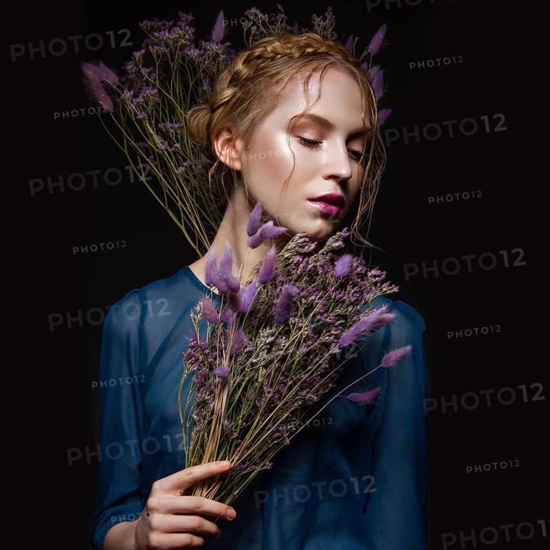 Beautiful girl with a gentle make-up and hairstyle in the form of braids