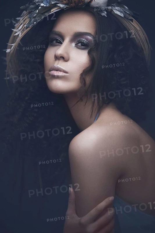 Beautiful girl in a light blue dress and long hair in a fashionable image. Beauty fashion style. Picture taken in the studio with mixed light