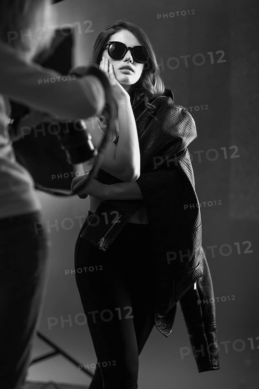 Beautiful girl posing on a photo shoot in the studio. Black and white image