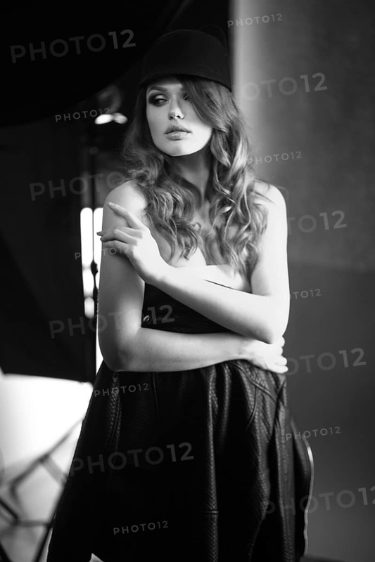 Beautiful girl posing on a photo shoot in the studio. Black and white image