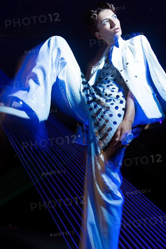 Fashion model beautiful girl in fashionable clothes in ultraviolet light