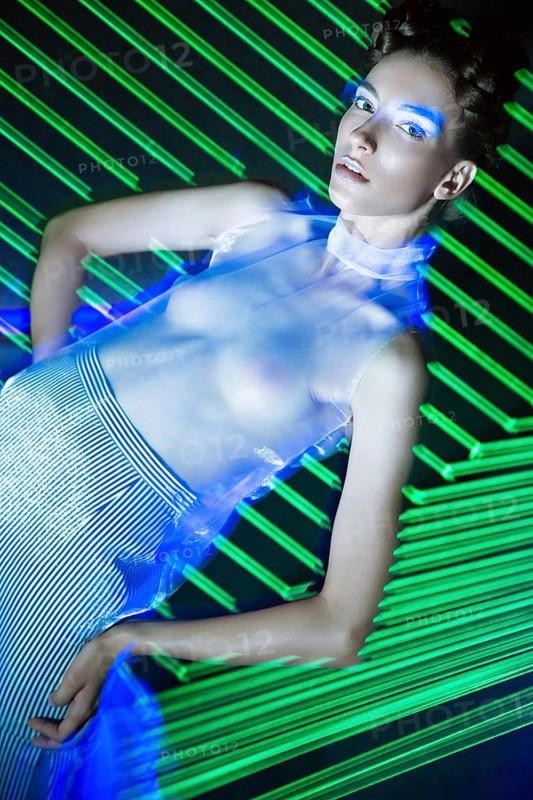 Fashion model beautiful girl in fashionable clothes in ultraviolet light