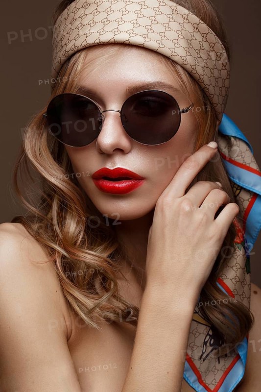 Beautiful girl in stylish clothes with sunglasses and red sexy lips. Beauty face. Photo taken in the studio