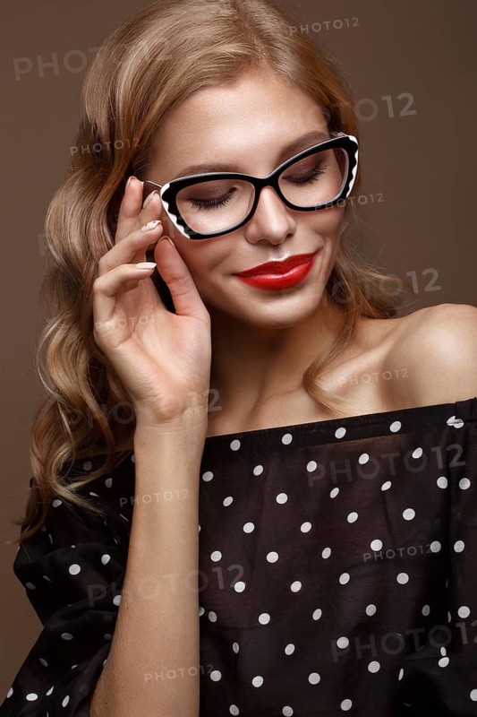 Beautiful girl in stylish clothes with glasses for vision and red sexy lips. Beauty face. Photo taken in the studio