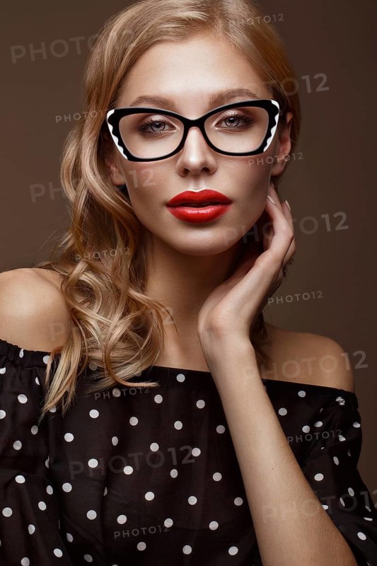 Beautiful girl in stylish clothes with glasses for vision and red sexy lips. Beauty face. Photo taken in the studio