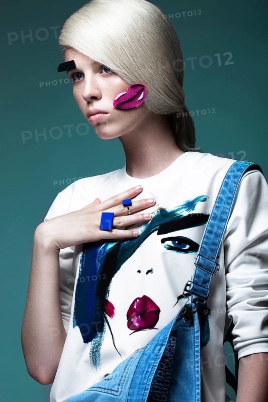 Fashionable girl with natural make-up in clothes with a picture in the style of pop art