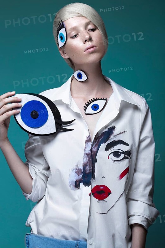 Fashionable girl with natural make-up in clothes with a picture in the style of pop art