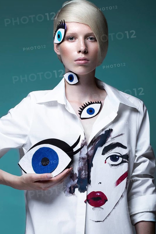 Fashionable girl with natural make-up in clothes with a picture in the style of pop art