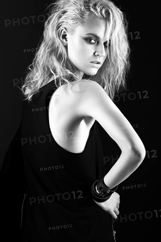 Daring girl model in black leather dress in the style of rock