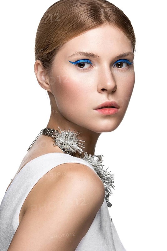 Beautiful fashionable girl with the blue arrows on the eyes