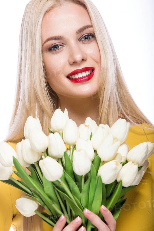 Portrait of beautiful fashion model with bouquet lily in hands