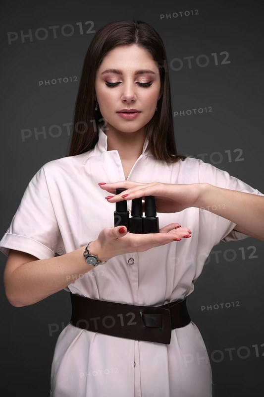 Manicurist in working form with tools in hand. Nail photo content