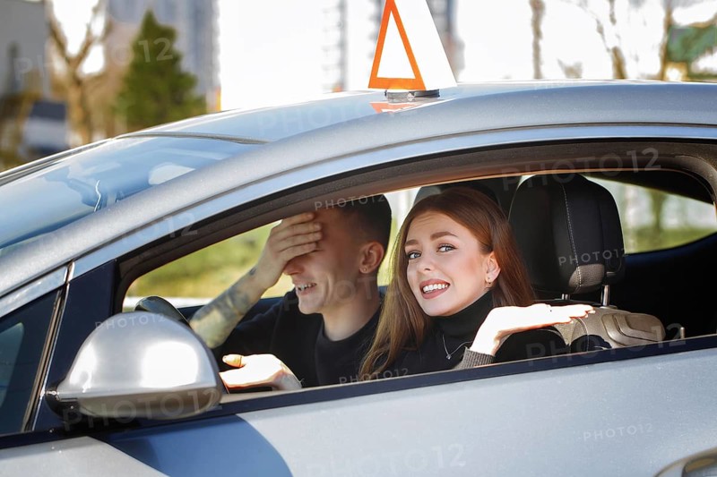 The driver is an auto school instructor and a female student on an examination car. Lesson at the circuit
