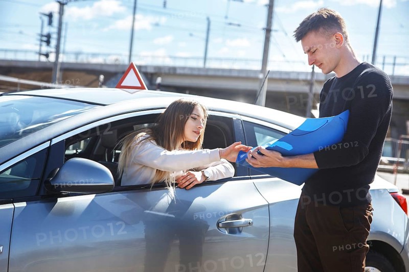The driver is an auto school instructor and a female student on an examination car. Lesson at the circuit