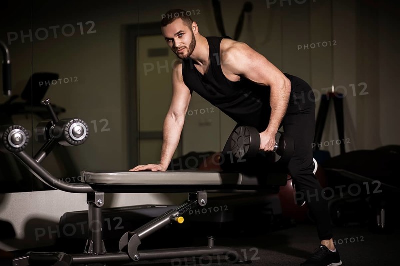 Sporty sexy men with great abdominal muscles in black sportswear