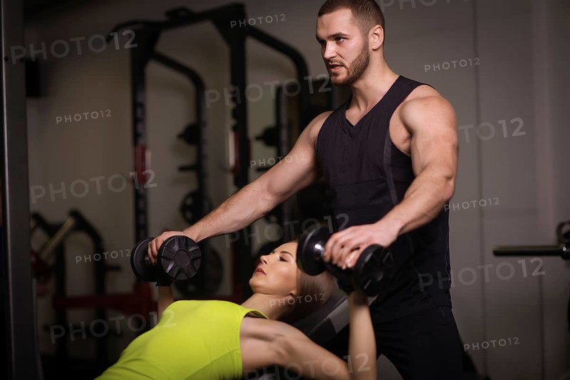 Sporty sexy man and woman with great abdominal muscles in black sportswear