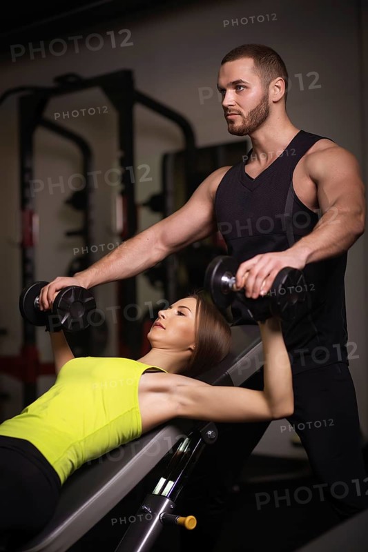 Sporty sexy man and woman with great abdominal muscles in black sportswear