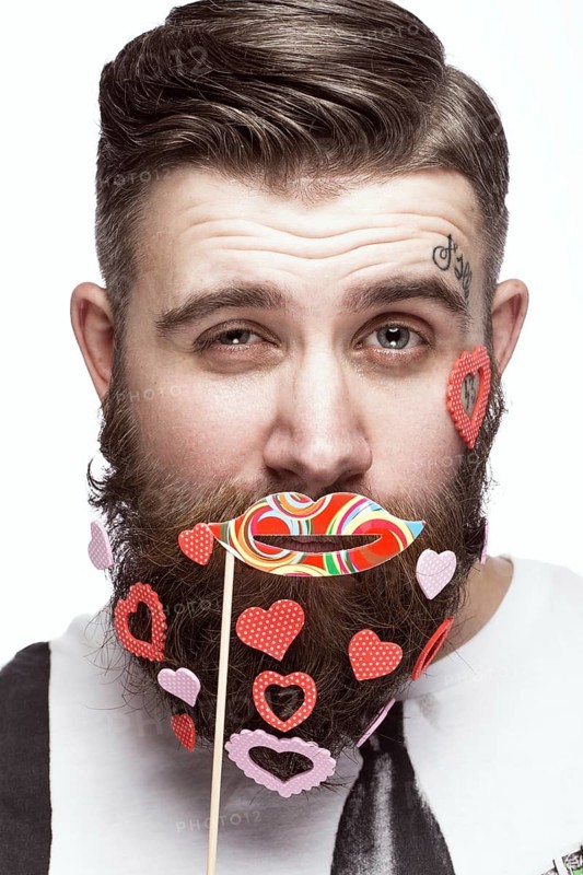 Funny bearded man with hearts Valentine's Day. Portrait shot in studio