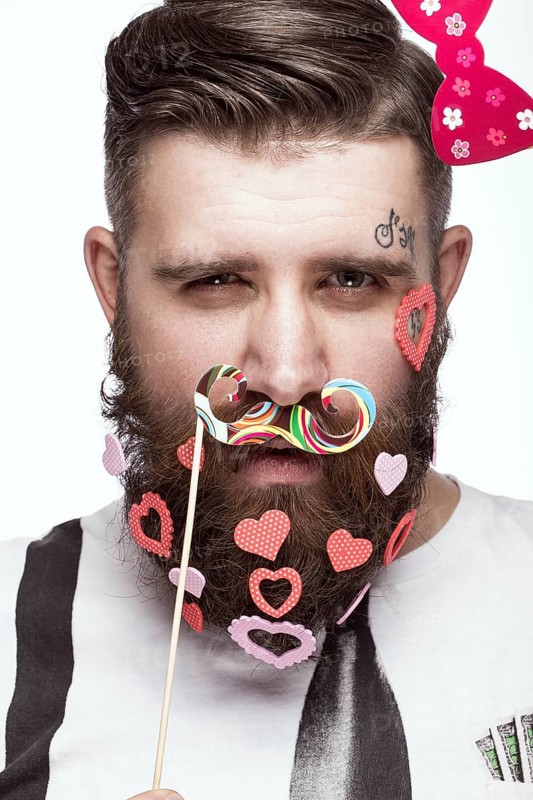 Funny bearded man with hearts Valentine's Day. Portrait shot in studio