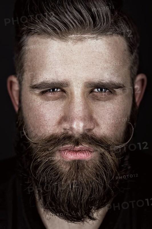A solid man with a beard and mustache. Photos shot in the studio