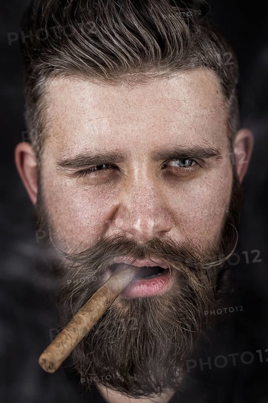 A solid man with a beard and mustache. Photos shot in the studio