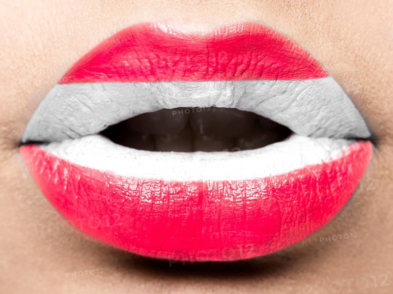 Female lips close up with a picture of the flag of Austria. white
