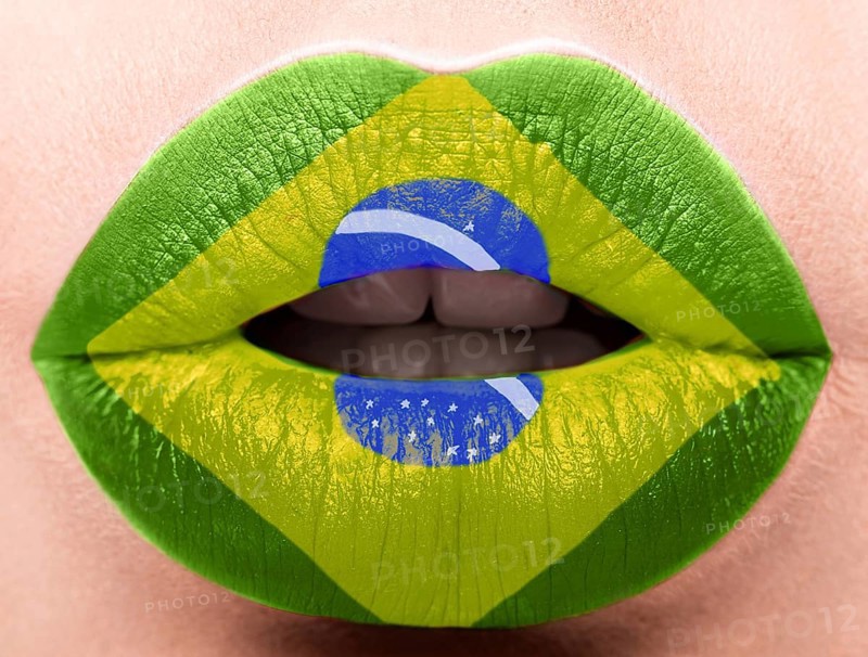 Female lips close up with a picture of the flag of Brazil. green