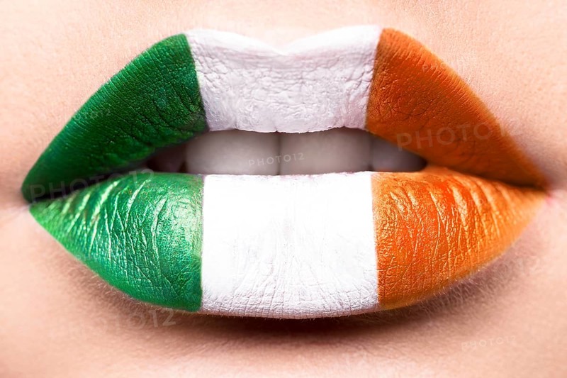 Female lips close up with a picture flag of Ireland. Green