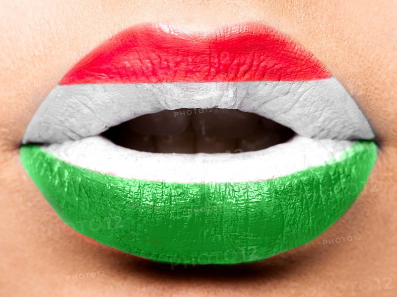 Female lips close up with a picture of the flag of Hungary. White