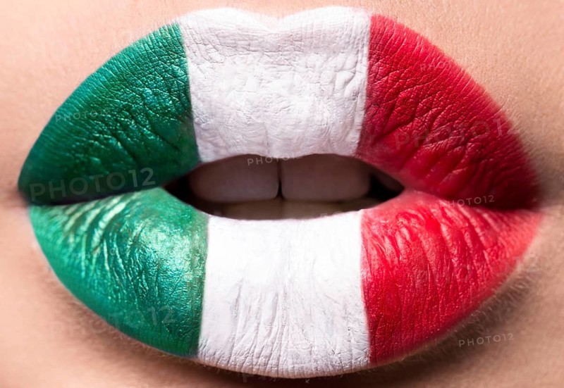 Female lips close up with a picture flag of Italy. Green