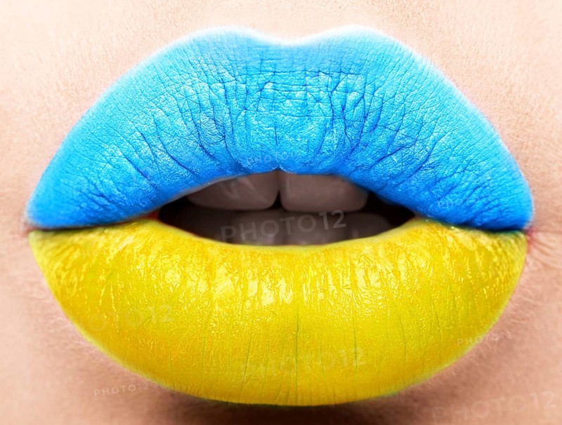 Female lips close up with a picture of the flag of Ukraine. Blue