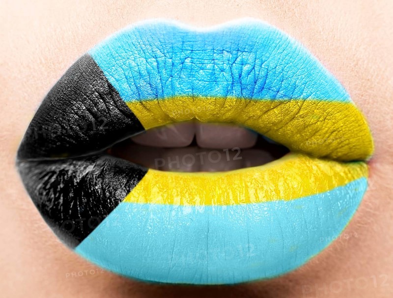 Female lips close up with a picture of the flag of Bagamy