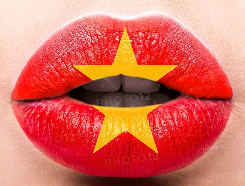 Female lips close up with a picture of the flag of Vietnam. Red