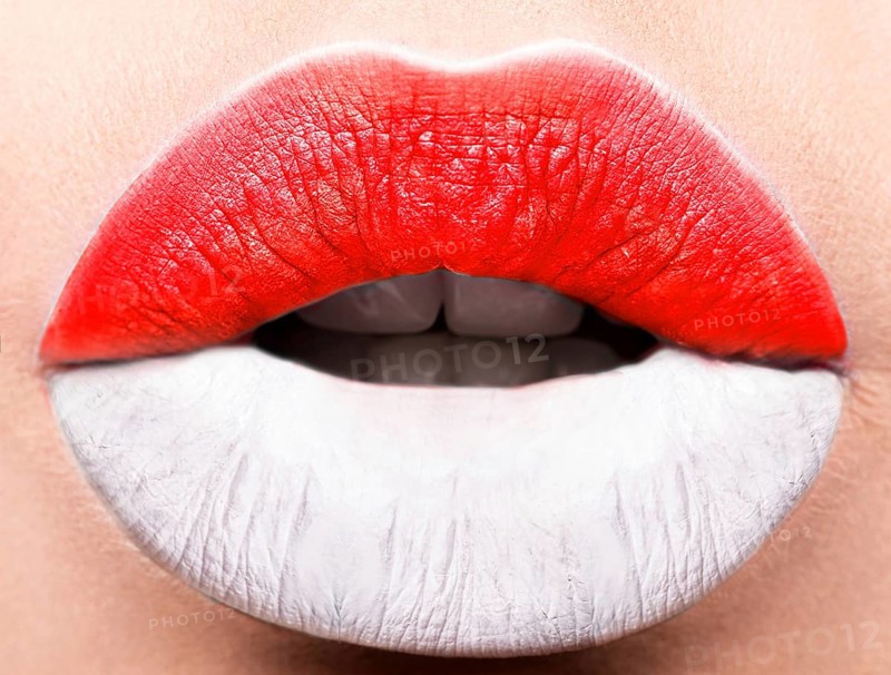 Female lips close up with a picture of the flag of Indonesia. white