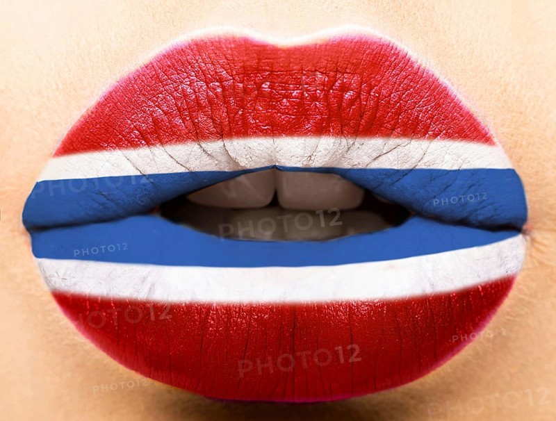 Female lips close up with a picture of the flag of Latvia. white