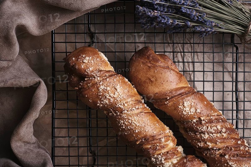 White bread in a basket and lavender flowers in vintage style