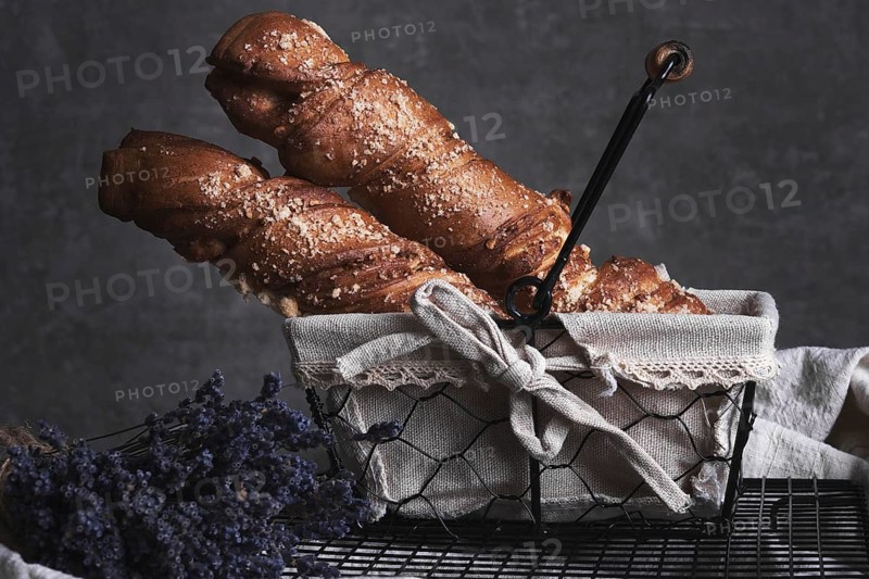 White bread in a basket and lavender flowers in vintage style