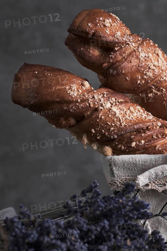 White bread in a basket and lavender flowers in vintage style