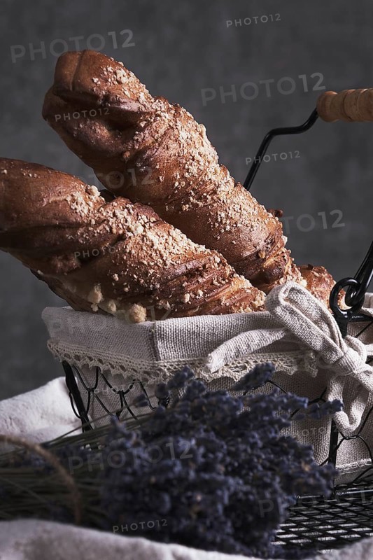 White bread in a basket and lavender flowers in vintage style