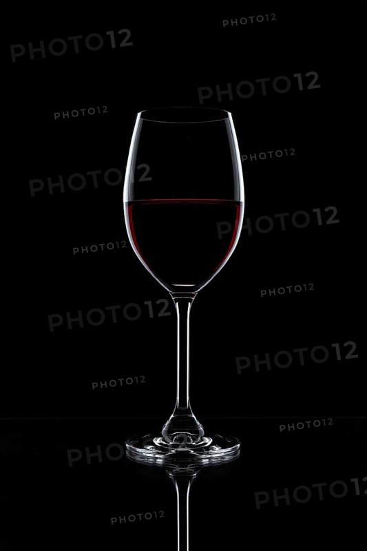 Red wine in a glass isolated on black background
