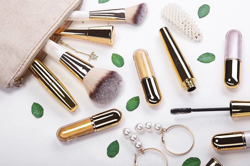 Set of brushes and cosmetic products in a cosmetic bag on a white background