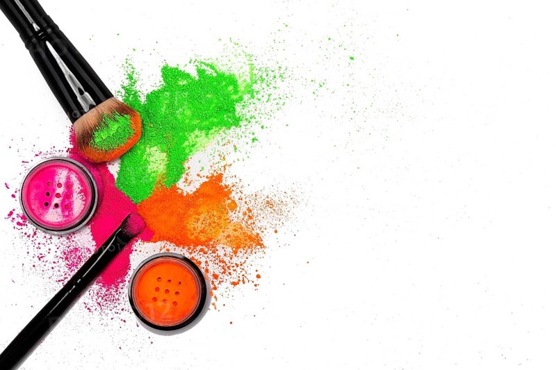 Cheek brush with neon cosmetic powder colorful pile and isolated on white background