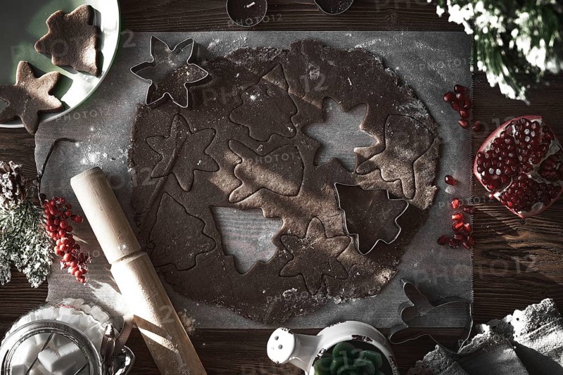 Preparing Christmas cookies. Dough on the table with baking dishes
