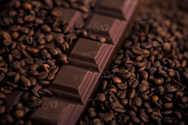 Roasted coffee beans and chocolate bar close-up