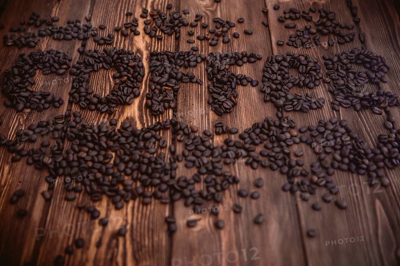 Roasted coffee beans close-up on a wooden surface